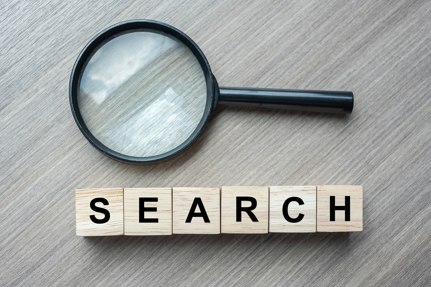 Search text wooden cubes and magnifying glass on wood table background. SEO, Idea, Vision, Strategy, Analysis, Keyword and Content concept